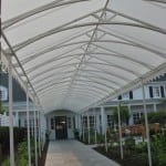 Half round awning over a long sidewalk.