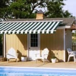 Pool house with a retractable awning.