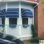 Quarter round awnings over three small windows.