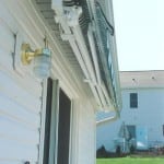 Awning retracted under the lip of a roof.