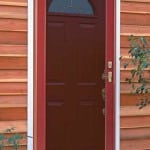 Windowed door with a storm door.