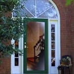 Glass door with a half circle transom and sidelights.