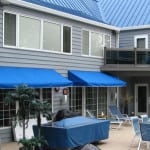 Blue awnings over patio area.